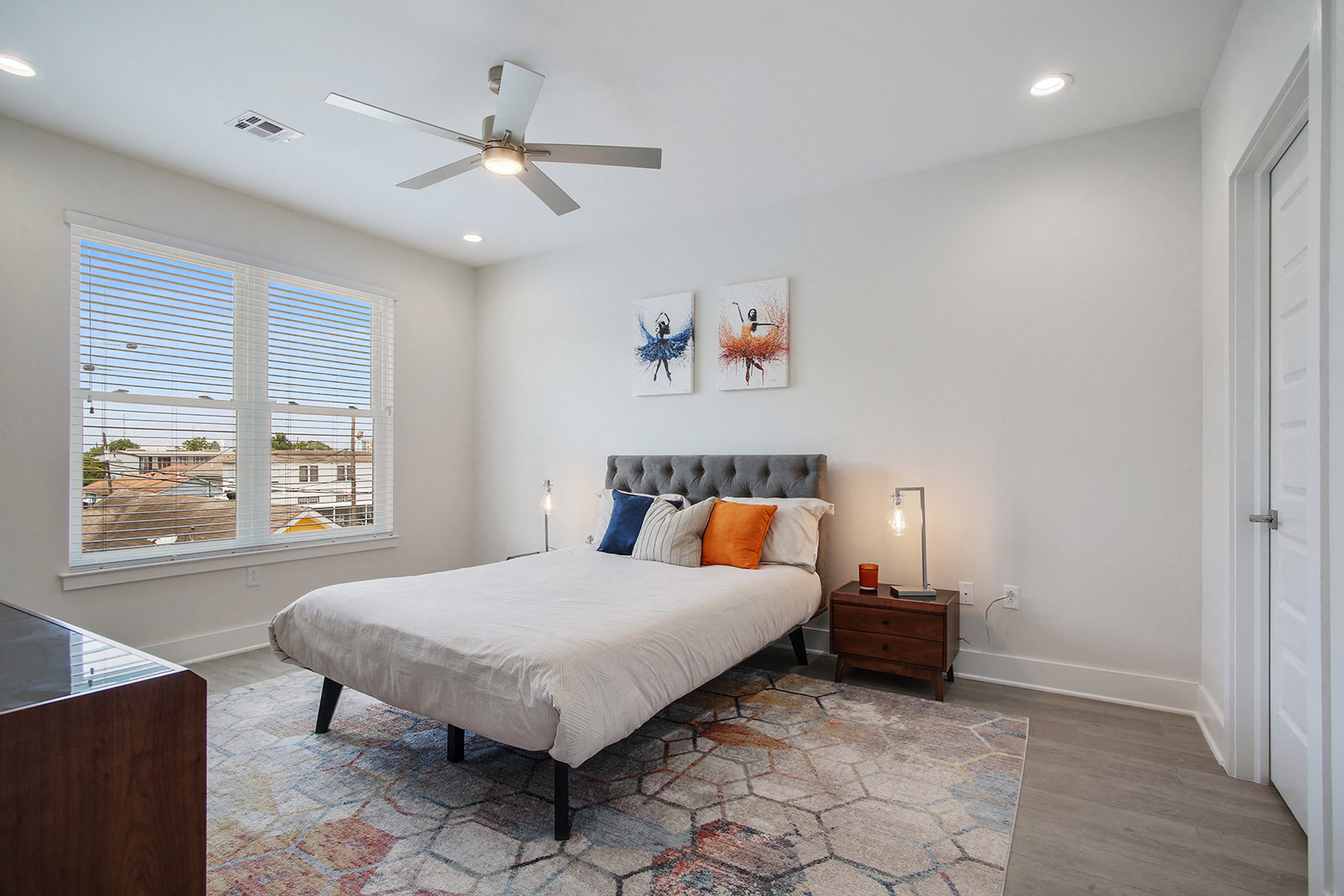 a bedroom with a bed and a ceiling fan