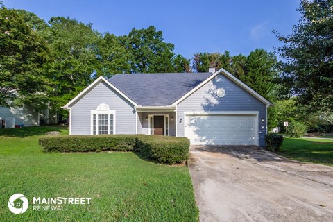 a blue and white house with a driveway and a garage door