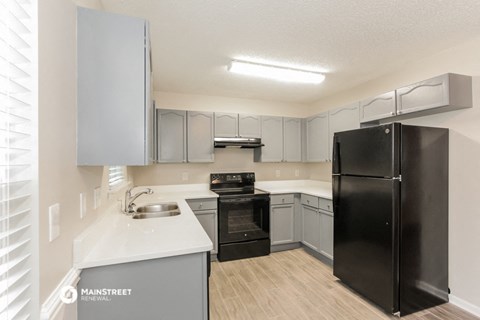 the preserve at ballantyne commons apartment kitchen with black appliances and white countertops