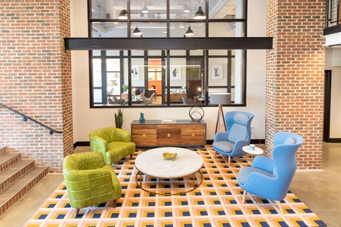 a living room with blue and green chairs and a coffee table
