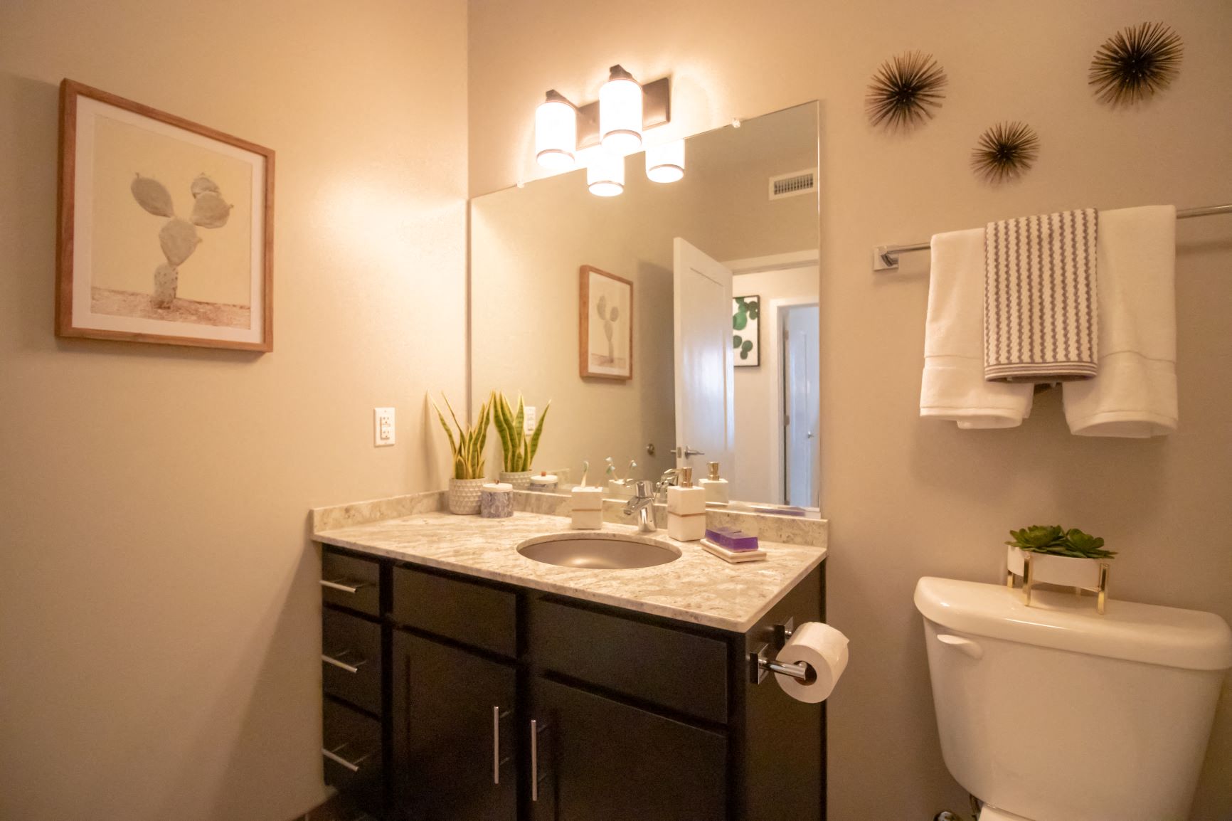 The bathrooms at Penstock Quarter feature under mount stainless steel sinks and granite counter tops.