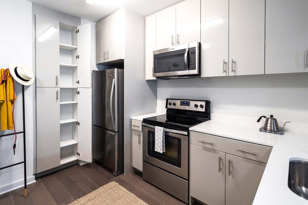 a kitchen with stainless steel appliances and white cabinets