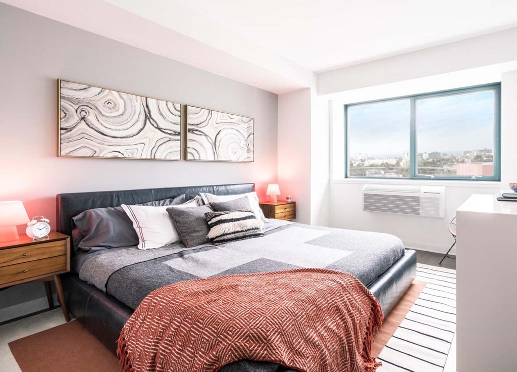 a bedroom with a bed and a window