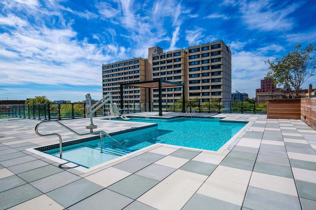a swimming pool with a building in the background