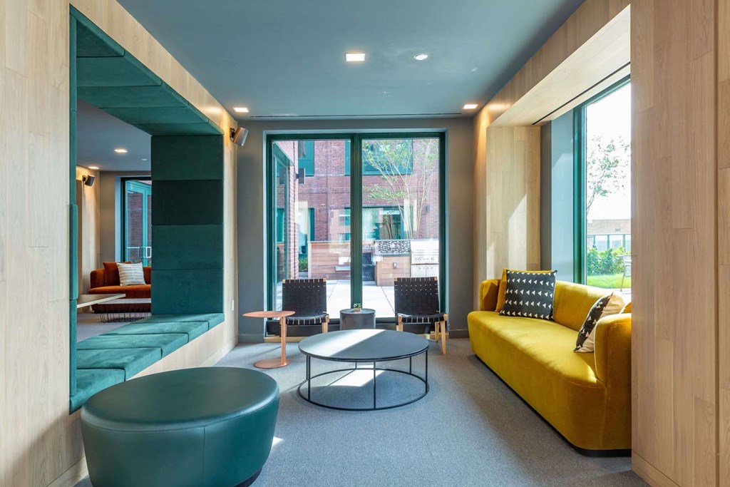 a living room with a yellow couch and a table