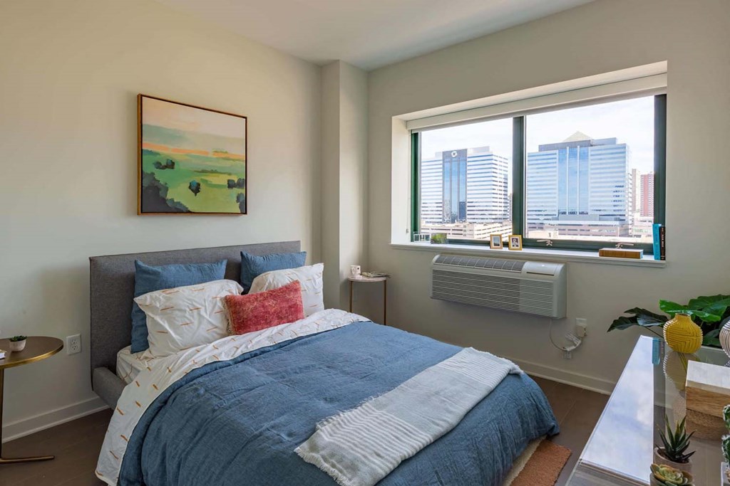 a bedroom with a bed and a window