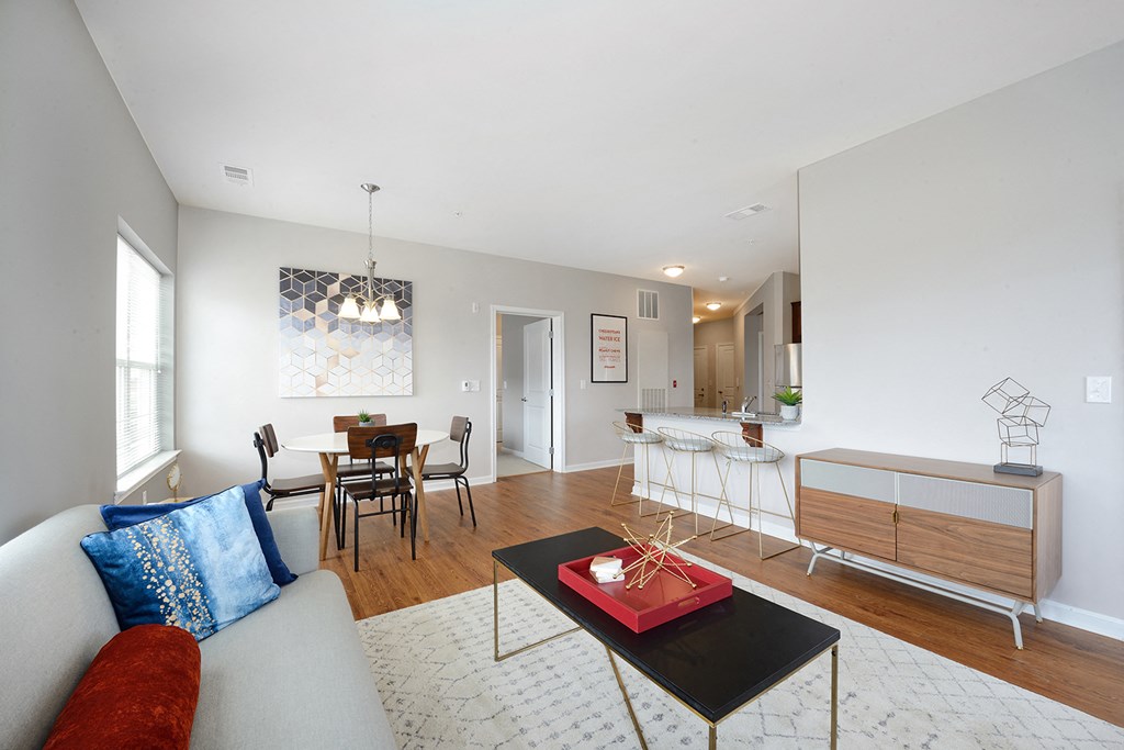 a living room with a couch and a coffee table and a dining room