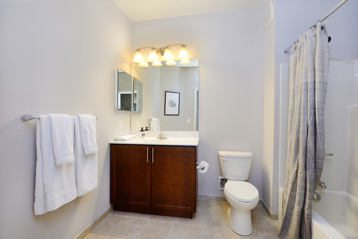 a bathroom with a toilet and a sink and a shower