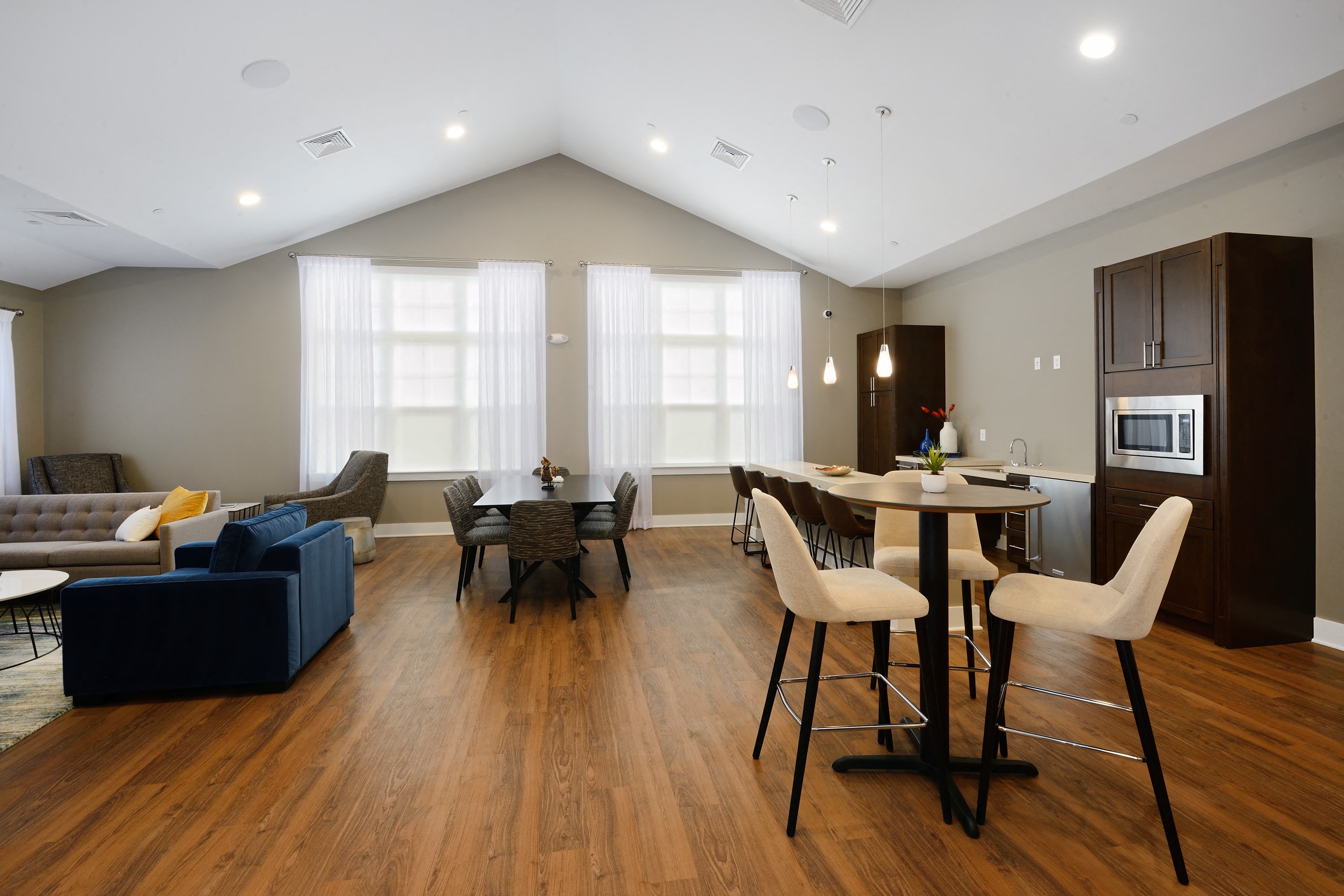 a living room and dining room with a table and chairs