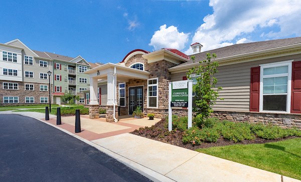 an exterior view of a building with a sign in front of it