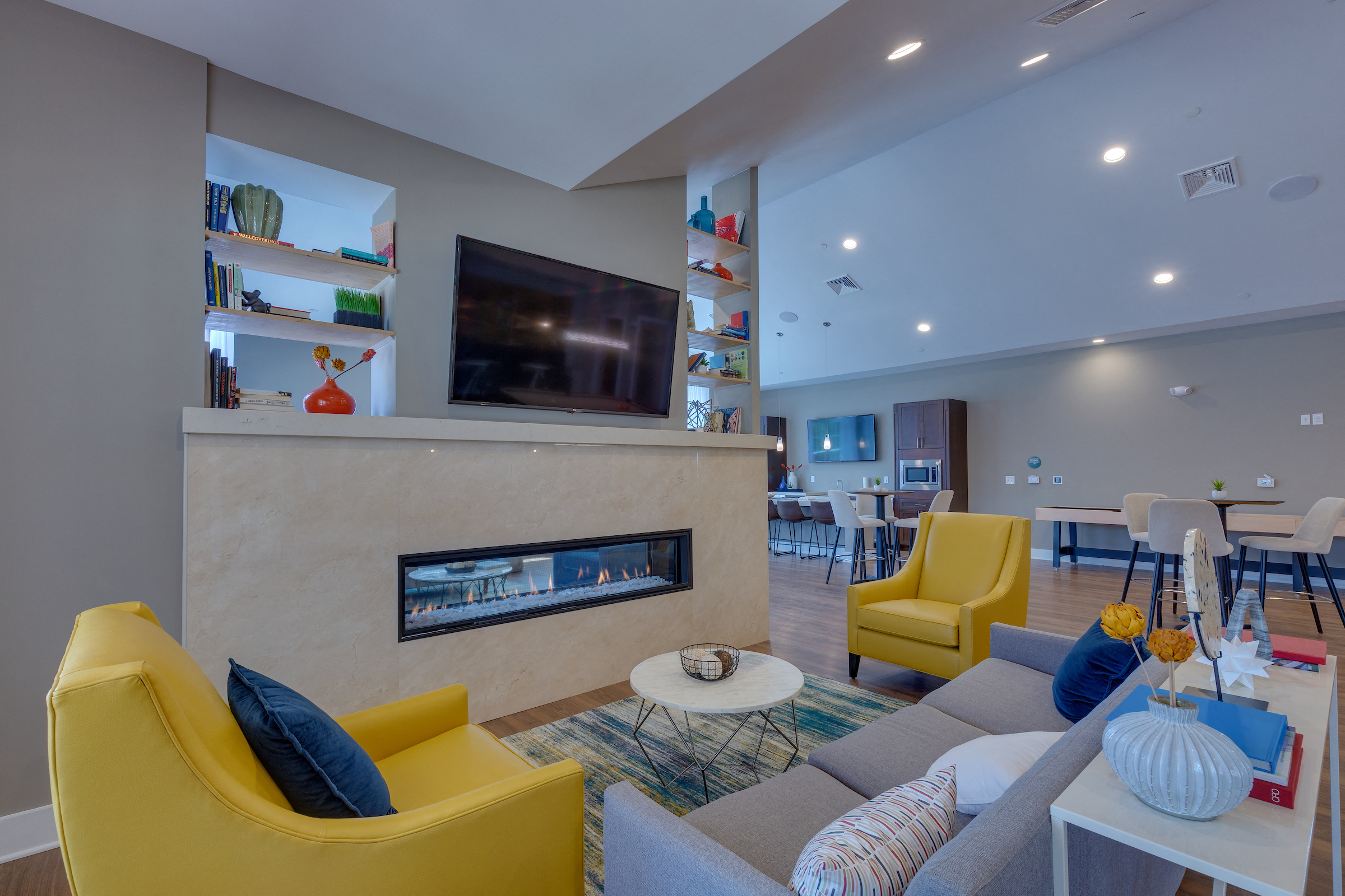 a living room with couches and chairs and a fireplace