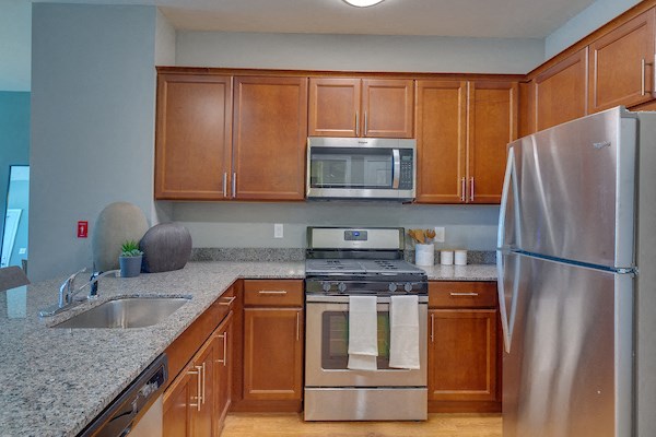a kitchen with stainless steel appliances and granite counter tops