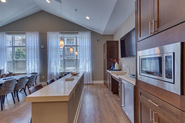 a kitchen and dining room with a table and chairs and a television