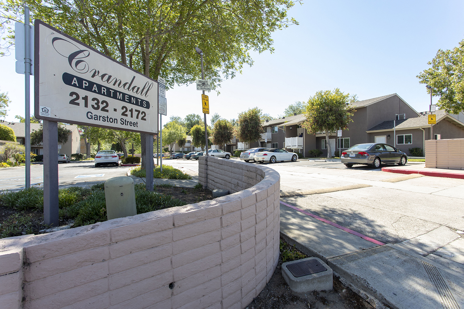 a sign for a car dealership on the corner of a street
