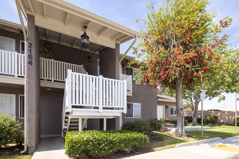 a white porch swing in front of an apartment building