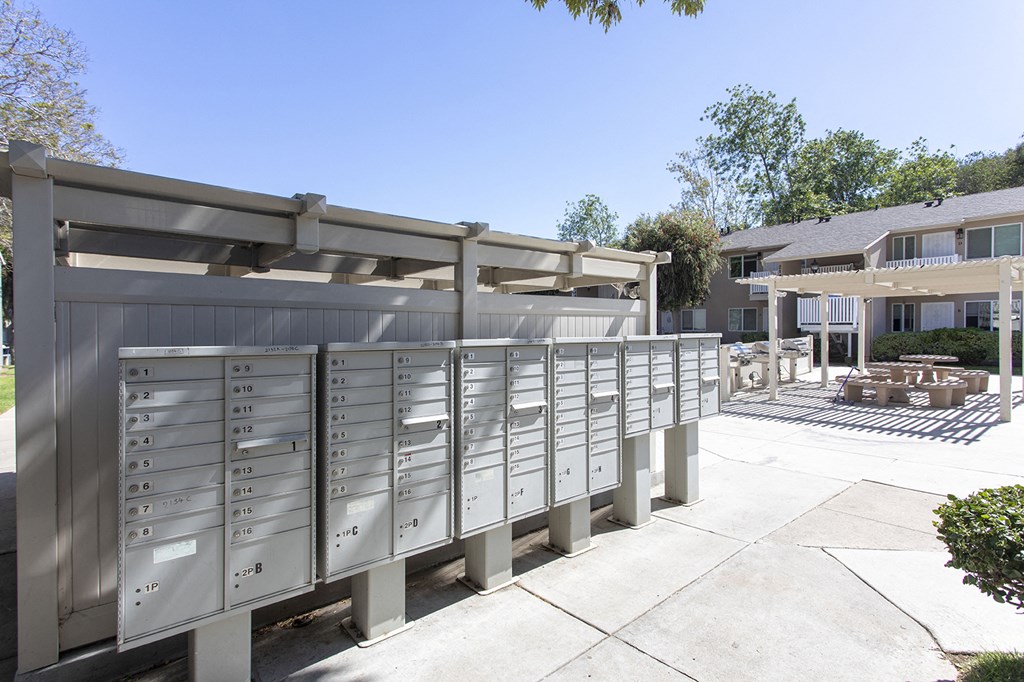 the mailbox dropoff area of a house with mailboxes