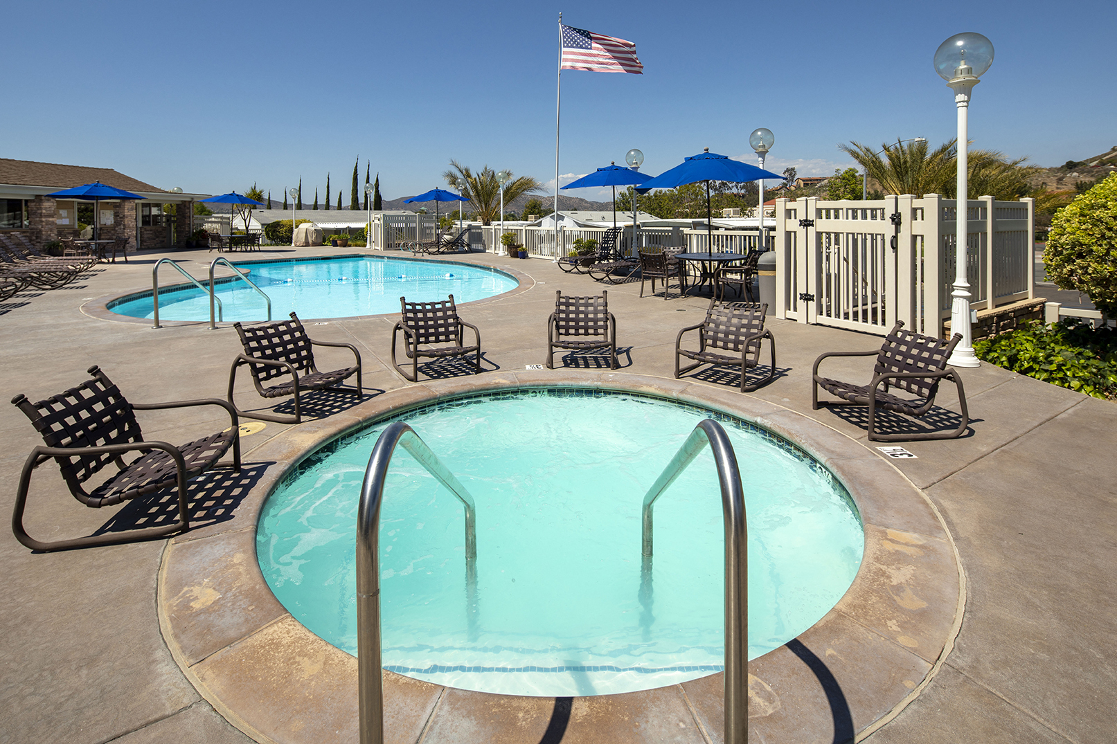 View of community spa with pool behind it