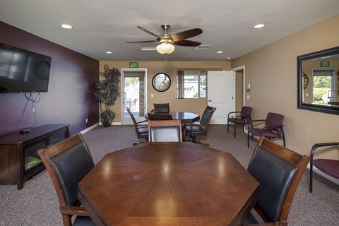 a dining room with a table and chairs and a ceiling fan