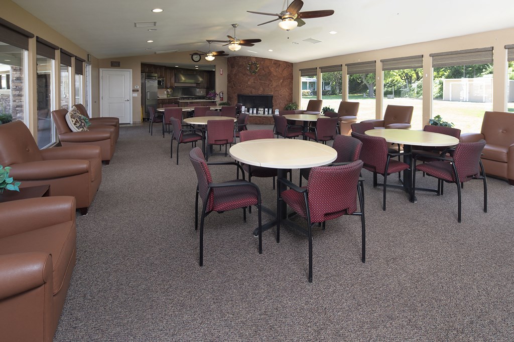 a dining room with tables and chairs and a fire place