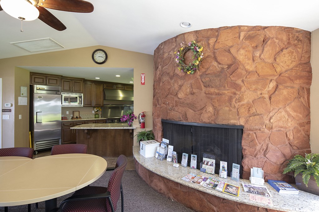 a living room with a fireplace and a table with chairs