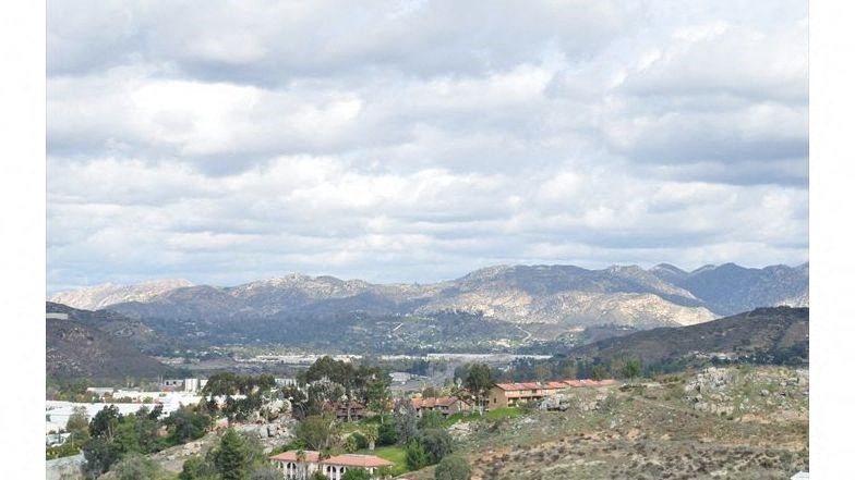 a view of a valley with mountains in the background