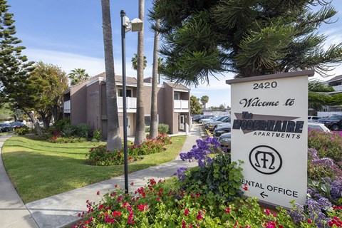 Modernaire Community Clubhouse building , with path, Modernaire Apartments sign, and landscaping