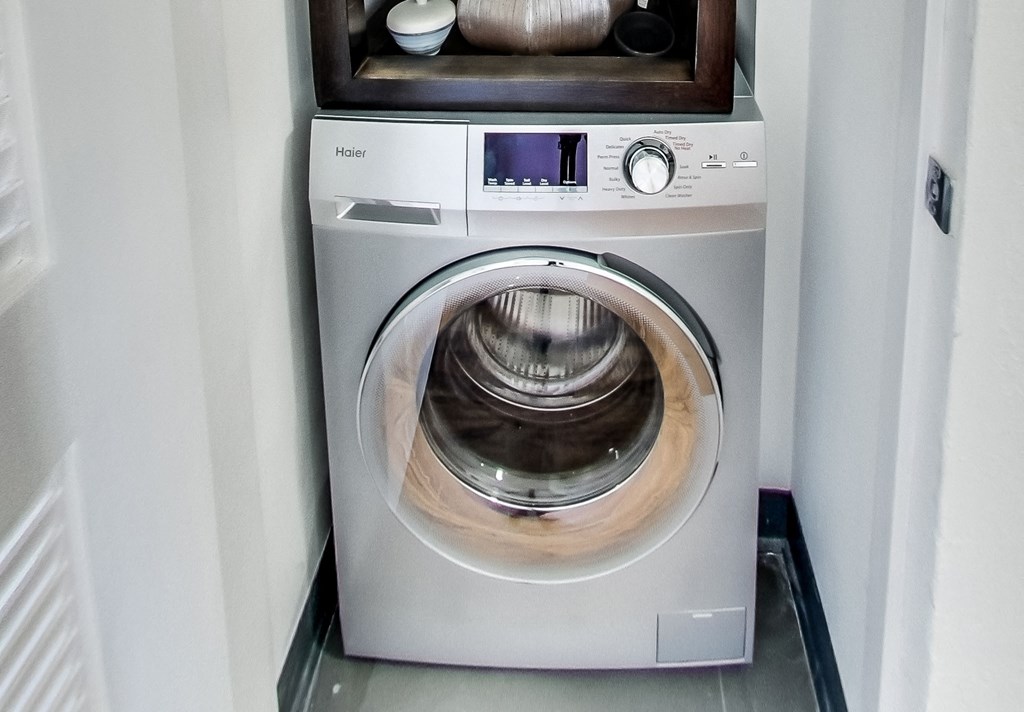 a white washer and dryer in a small room