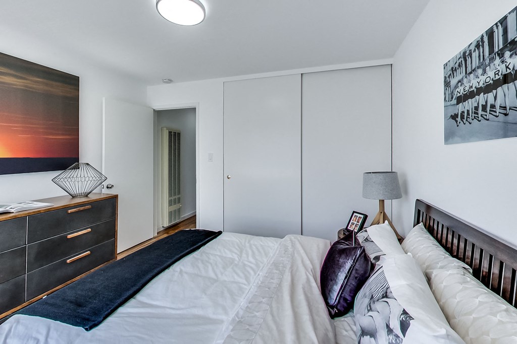 a bedroom with a large bed and a dresser