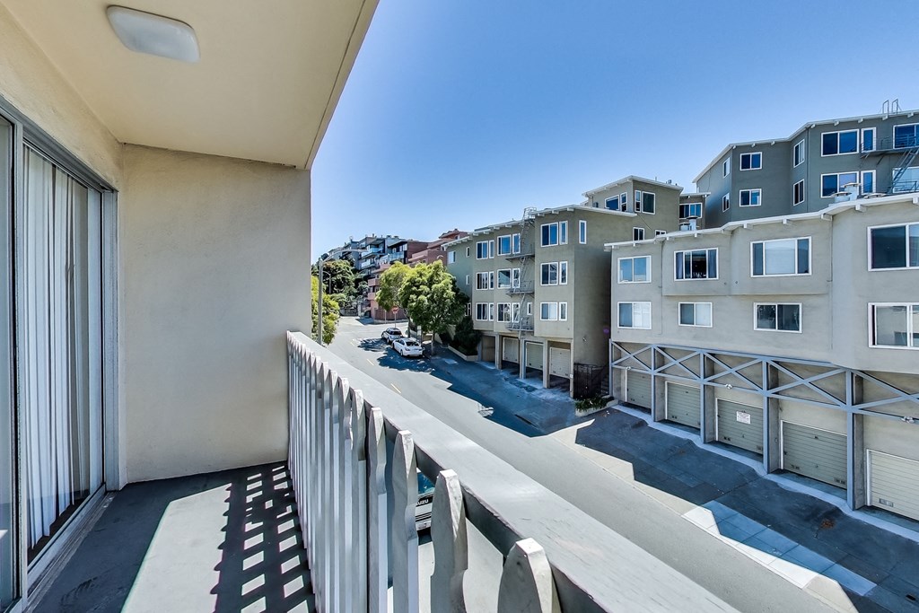 the view from the balcony of an apartment building on a sunny day