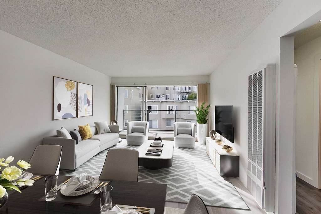 a living room with a white couch and chairs and a television