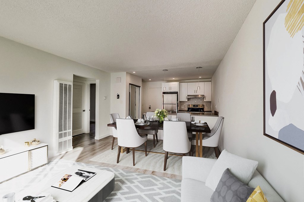 a living room and dining room with a table and chairs