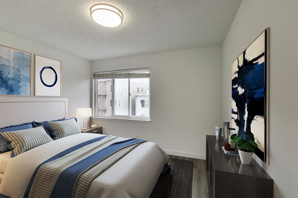 a bedroom with a large bed and a window