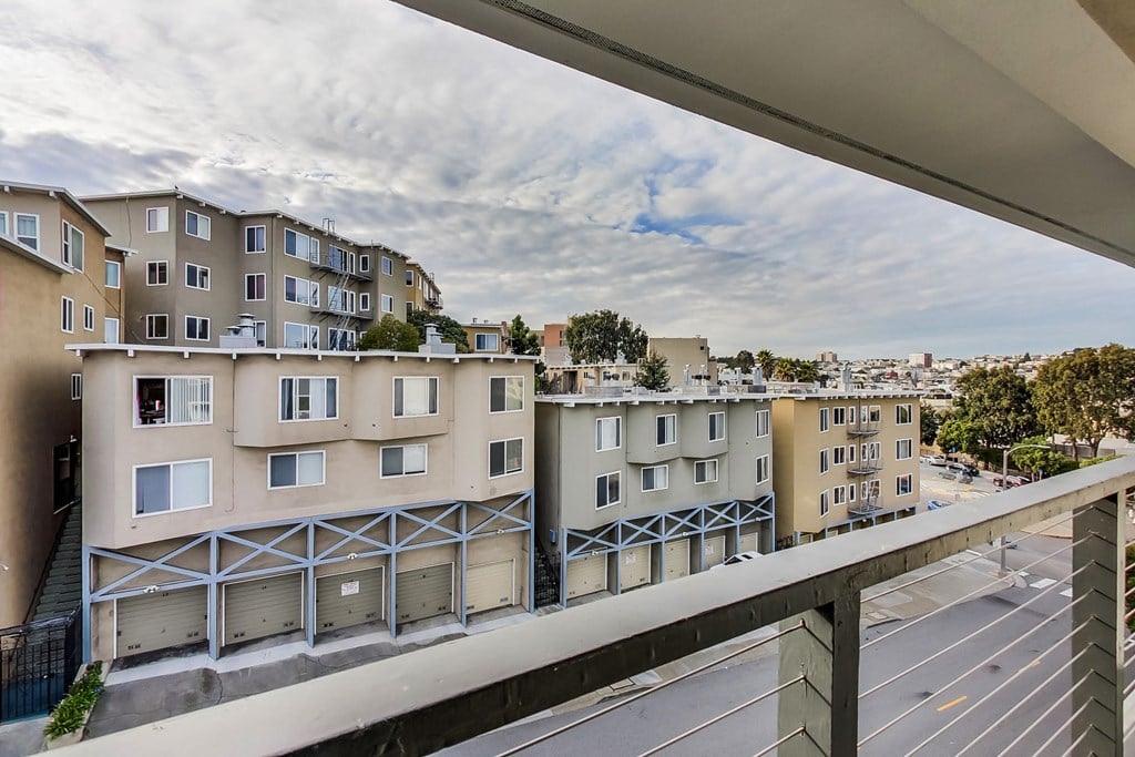 the view from the balcony of an apartment building in the city