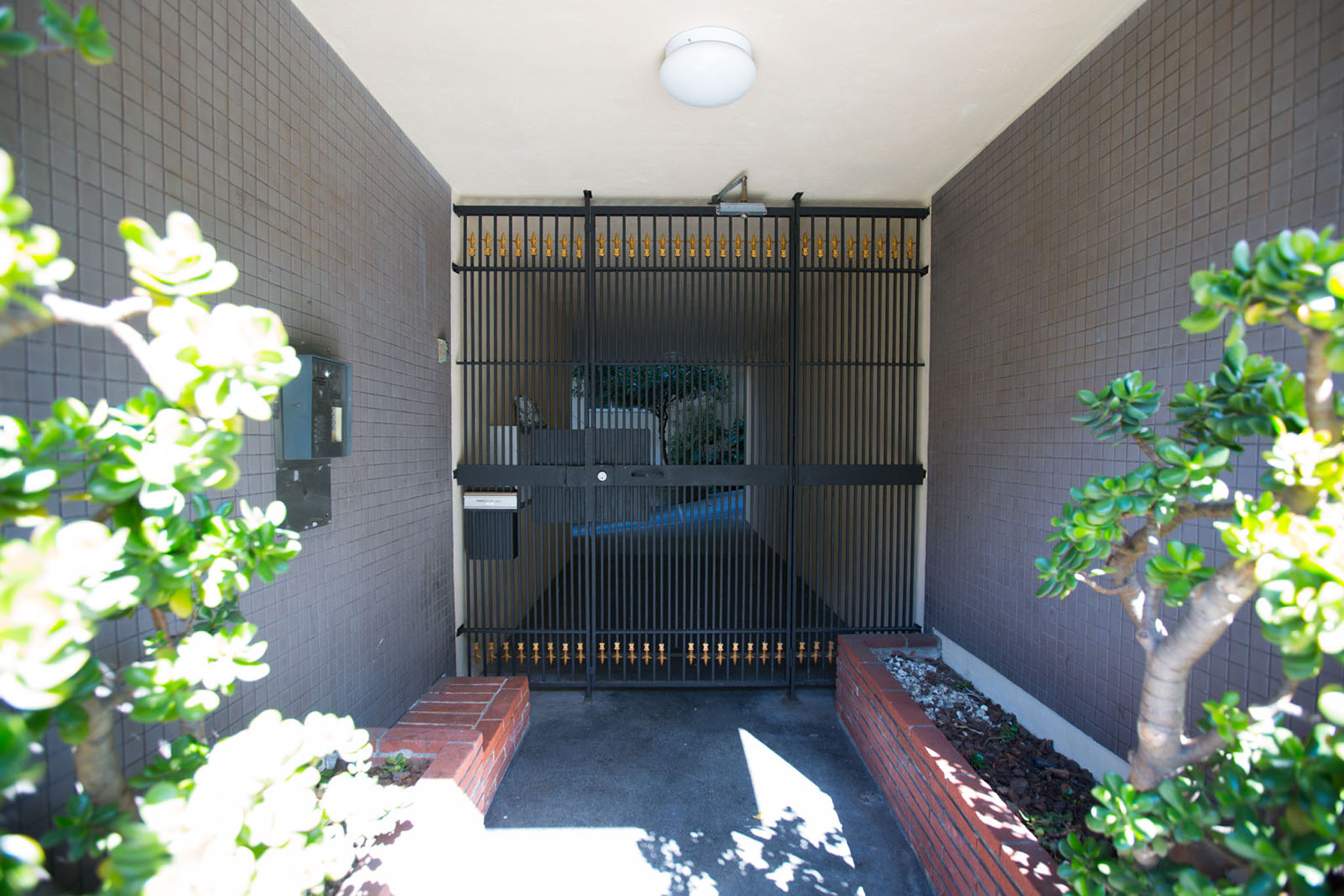 A small, dark room with a bench and a gate.