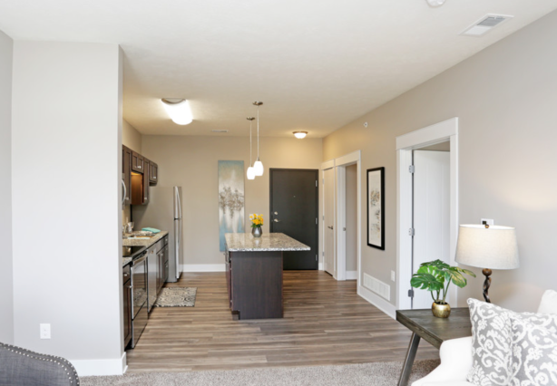a living room with a kitchen and a table