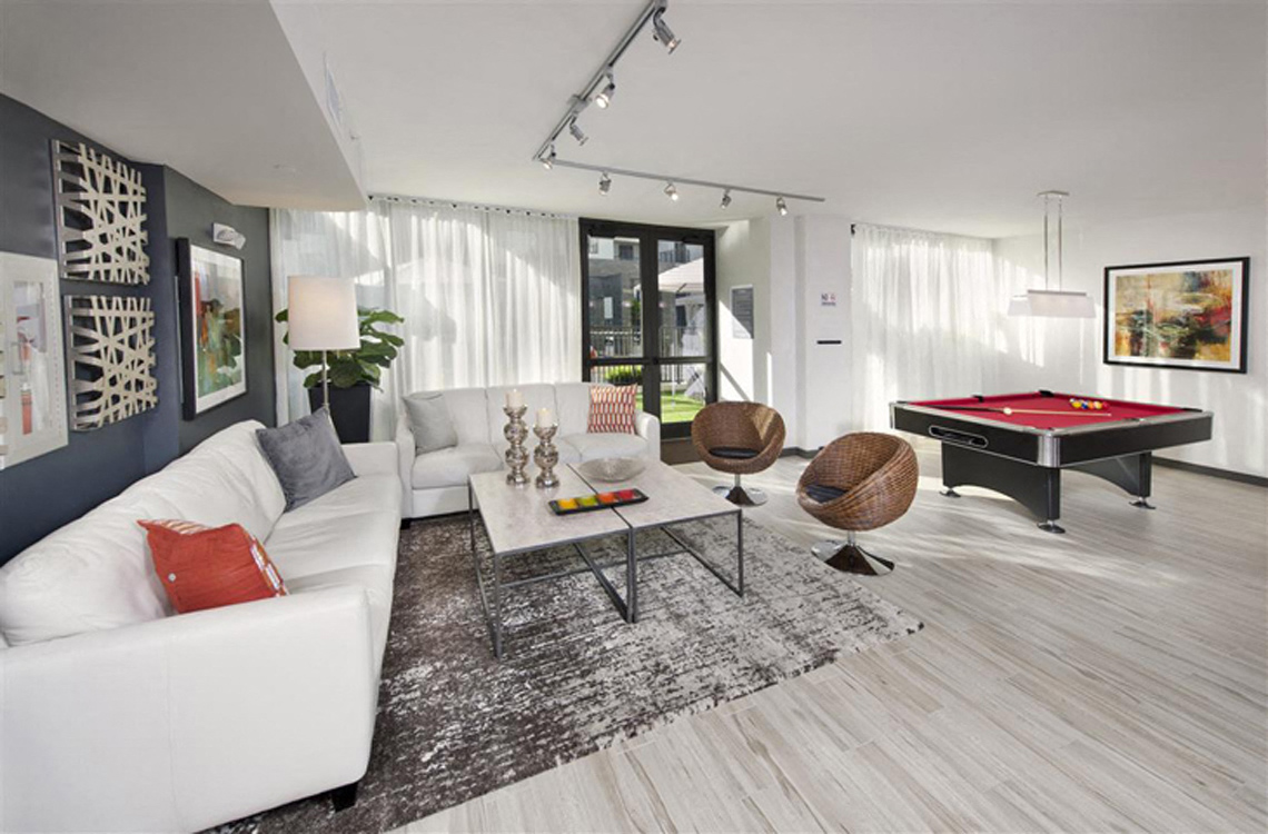 a living room with a pool table and a white couch