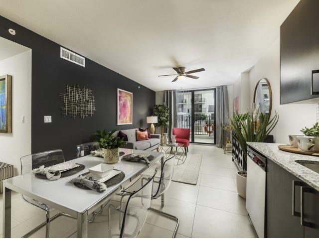 a living room and dining room with a table and chairs