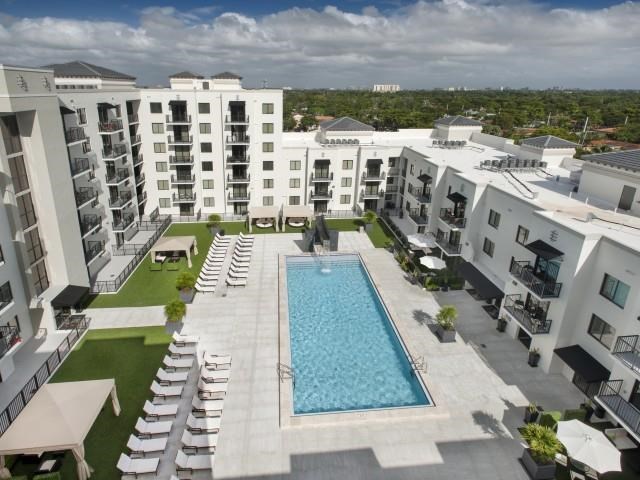 an aerial view of a swimming pool in an apartment building