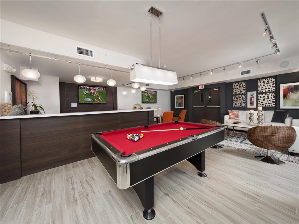 a red pool table in a billiards room