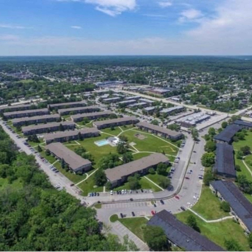 an aerial view of an industrial area with cars on the road