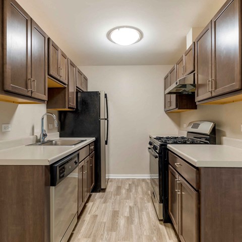 a kitchen with stainless steel appliances and wooden cabinets