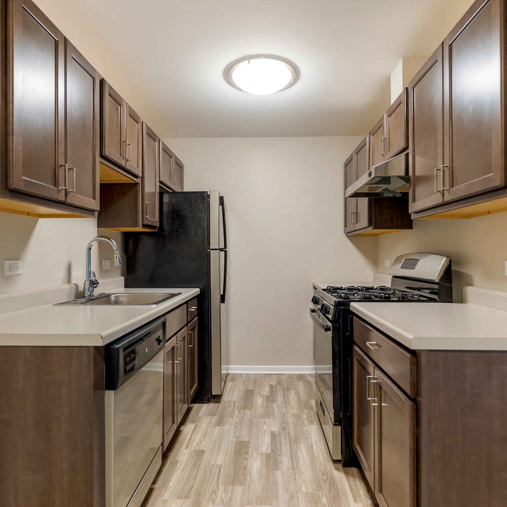 a kitchen with stainless steel appliances and wooden cabinets