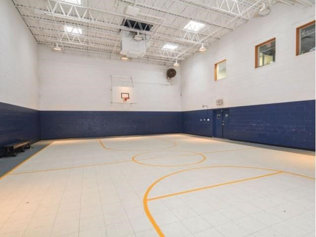 the inside of a gym with a basketball court