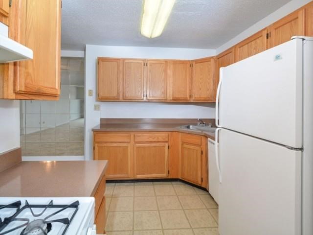 a kitchen with a stove and a refrigerator