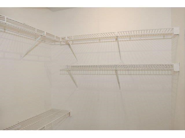 a white closet with two empty shelves in it