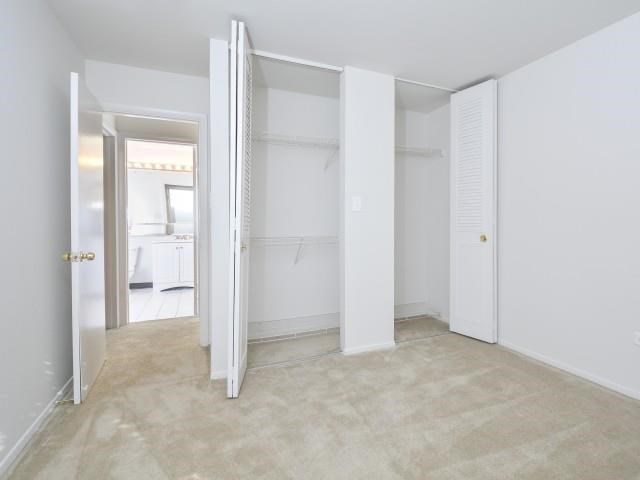 an empty room with white walls and a closet