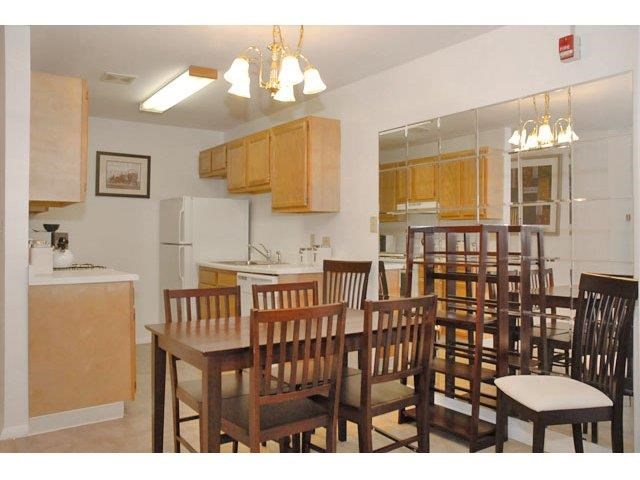 a kitchen with a dining table and chairs