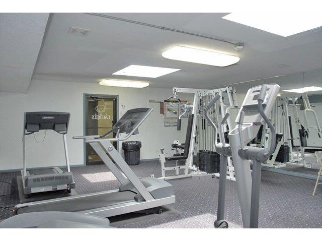 a gym with weights and other equipment in it
