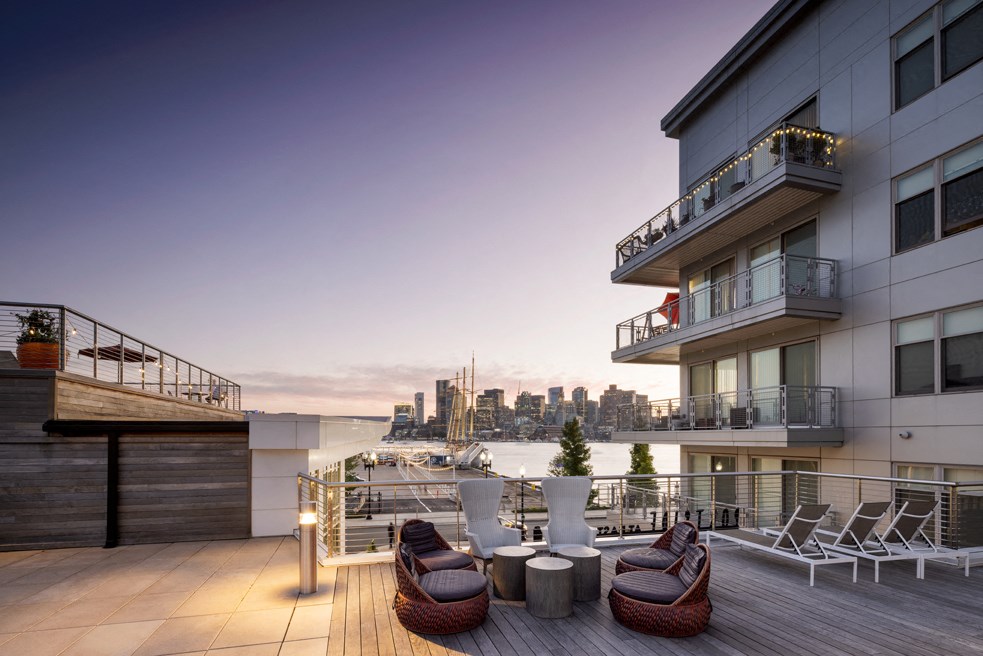 a roof terrace with a view of the city and the water