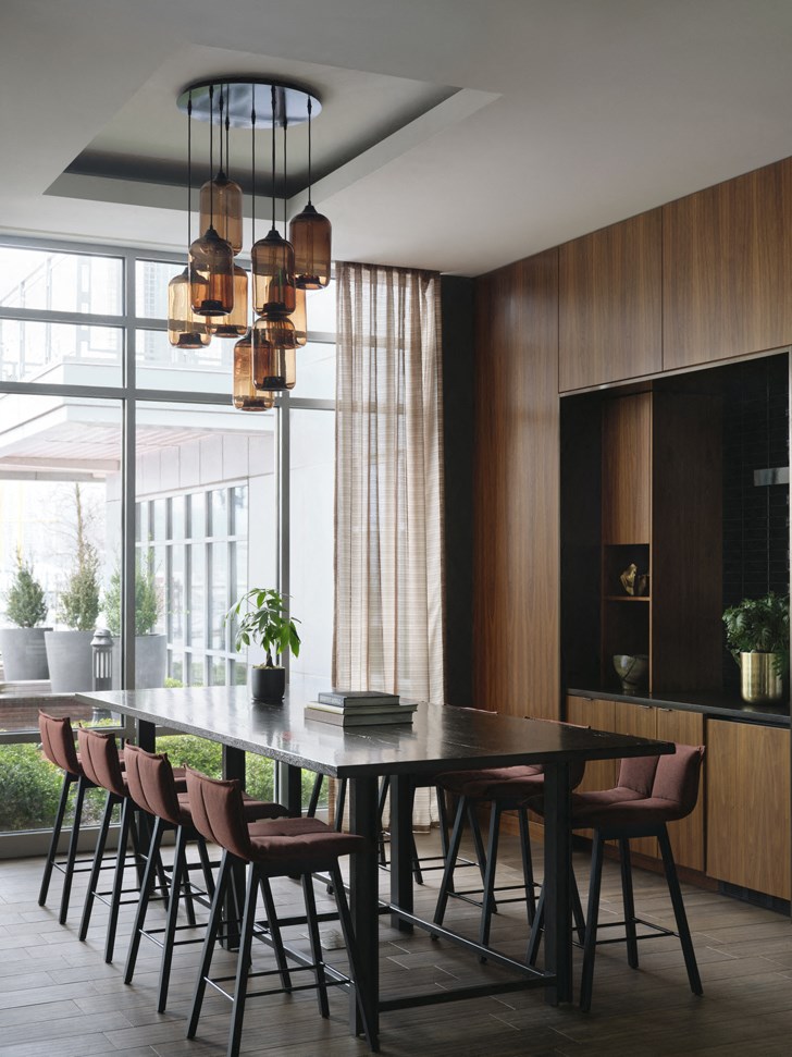 a dining room with a table and chairs and a large window